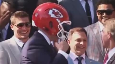 Biden Bizarrely Puts On Chiefs Helmet, Mirrors Michael Dukakis Moment