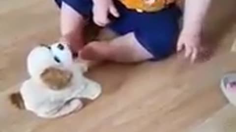 baby laughing with his toy dog