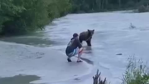 Merciful man catching fish to help Hungary bear!