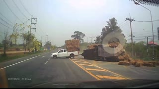 Truck Hauling Massive Straw Load Takes Turn too Fast