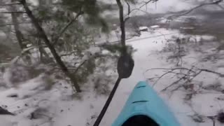 Michael Sliding a Kayak Down a Big Snowy Hill with Dogy