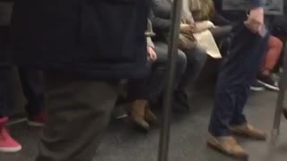 Man on subway sleeps with jacket on head