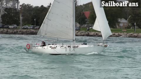 Random White Sailboat Light Cruise Under Bluewater Bridges In Great Lakes