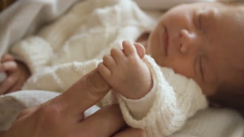 Close Up Video of a Newborn Baby Holding a Finger