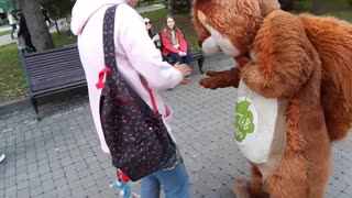 A kind girl feeds a squirrel )