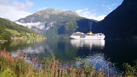 big cruise ship in the geiranger fjord in norway