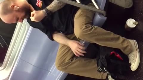 Man playing fake air guitar on train