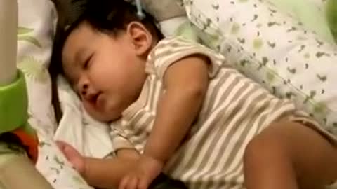 Baby laughing Adorably While Sleeping