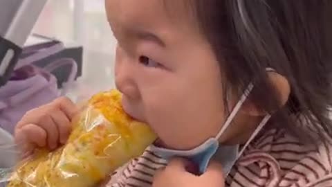 Cute toddler tries to eat bread while wearing face mask #shorts