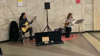 musicians on the subway play the violin