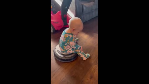 Thrill-seeking baby goes for ride on robot vacuum