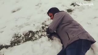 Guy tries to throw giant snow ball at blue shield drops on head