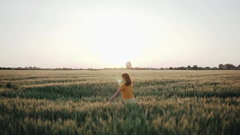 A Young Woman Running In The Wheat Fields