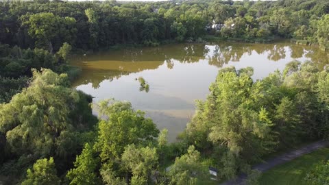 Neighborhood Pond at Sunset from a Drone