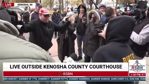 Protesters argue outside the Kenosha courthouse while awaiting the Rittenhouse verdict