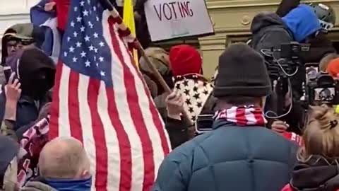 Trump supporters trying to stop Antifa from breaking window at Capital