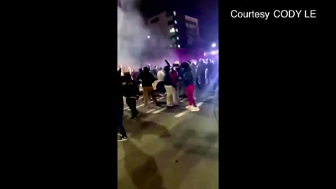 US police car charges crowd watching street race