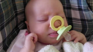 Adorable baby gets pacifier stuck on nose