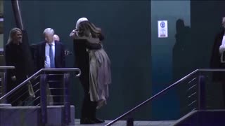 Assange hugs wife and father on landing in Australia