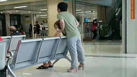 World's best boyfriend? Man wears girlfriend's pink high heels to let her rest her feet.