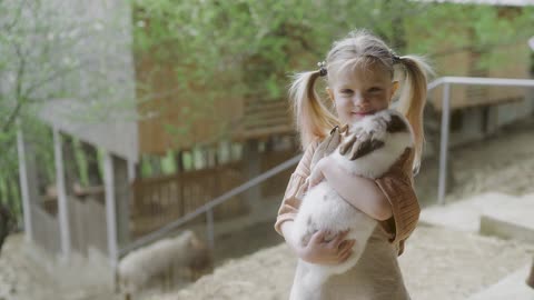 Cute and beautiful child holding rabbit