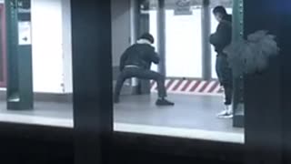 Guy stretches his legs at subway station