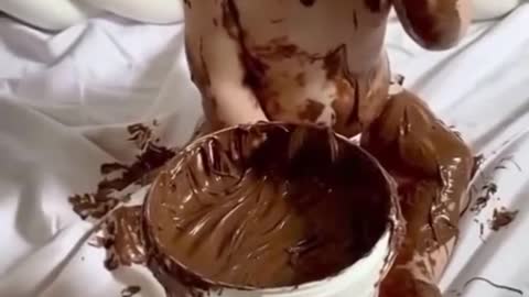 Cute baby play with chocolate. And doing very funny things.