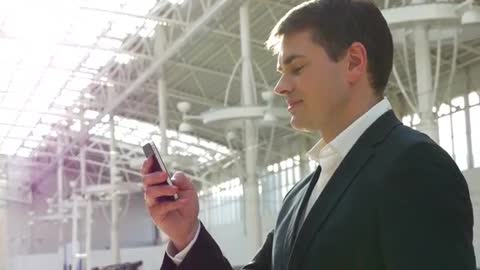 Handsome smiling young man under the steel structure