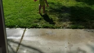 1 year old excited in sprinklers