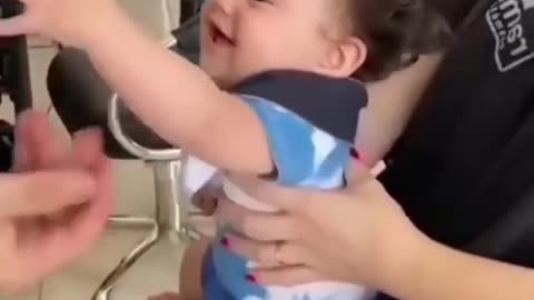 Cute baby cutting her hair