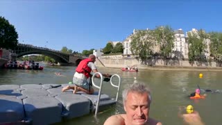 Paris mayor swims in Seine to prove water clean enough for Olympics | BBC News