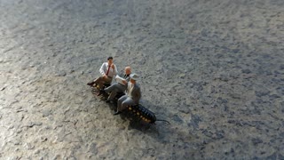 Figurines Ride Centipede to Work