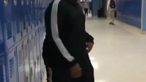 Kid in black outfit slams into blue lockers
