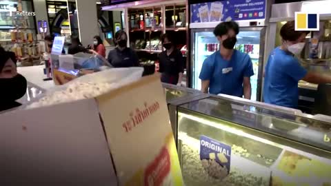 Customers fill steel vats, cardboard boxes with Thai cinema’s all-you-can-eat popcorn