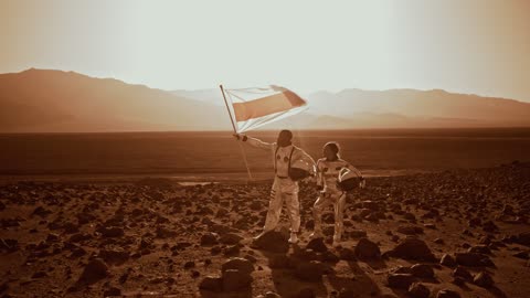 A man holding a flag against strong wind