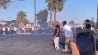 Man gets pocket checked and slapped after being hit by a car doing donuts