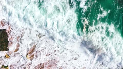 Nature's Symphony: Ocean Waves Dancing on Rocks