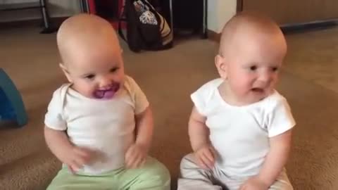 Peachy Twin baby girls fight over pacifier