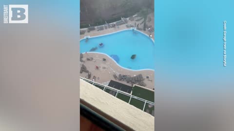 Severe Storm Sends Pool Loungers Flying, Family Seeks Shelter from Wild Winds