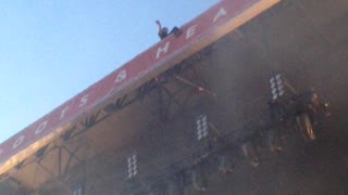 Guy Threatens To Jump Off Concert Stage Roof