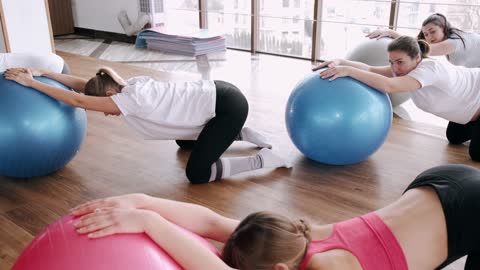women exercising with gum balls 2021