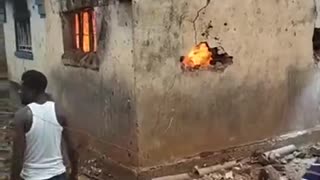 Some Men Attempt (Poorly) to Extinguish a Building on Fire...