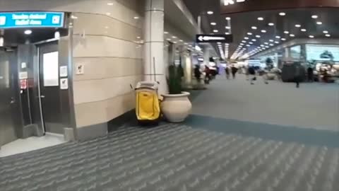 Cop On Bike Chases Woman On Motorized Suitcase Through Airport