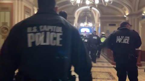 USCP guarding broken Capitol windows keeping protestors from getting in.