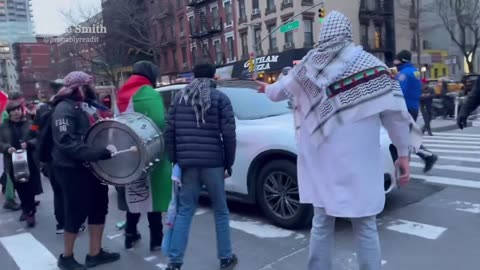 Car drives through angry mob of pro-Palestinian activists blocking the road in NYC today