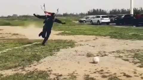 Skydiver Lands and Kicks Soccer Ball