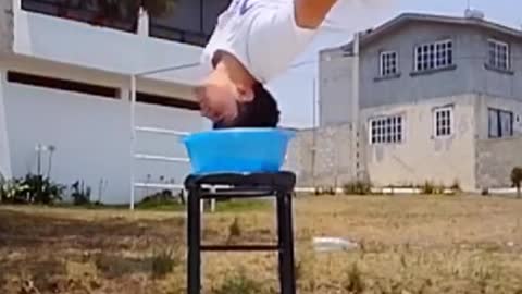 Guy Wets His Hair While Flipping Over Tub of Water