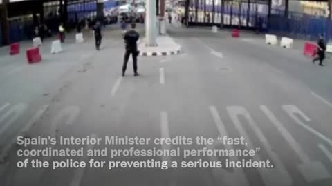 Spanish police throw traffic barrier at knife-wielding man