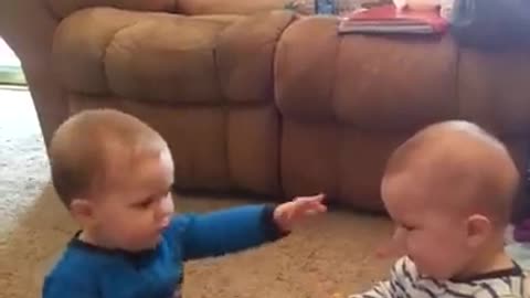 Twin babies have adorable fight