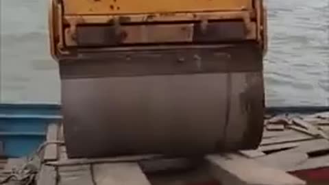 loading a steamroller onto a sketchy rickety ass boat